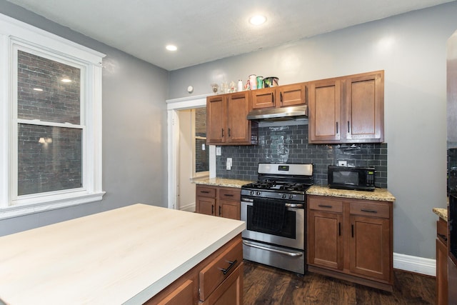 332 W 21st St, Covington, KY 41014 - kitchen with gas range, under cabinet range hood, black microwave, brown cabinets, and dark wood-style floors
