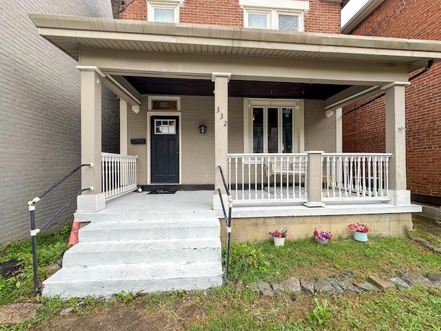 332 W 21st St, Covington, KY 41014 - view of exterior entry featuring covered porch and brick siding