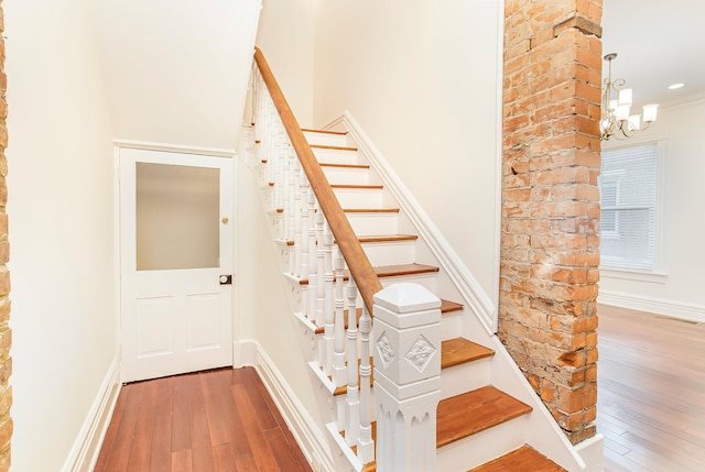 416 E 8th St, Newport, KY 41071 - stairway featuring hardwood / wood-style flooring and a chandelier