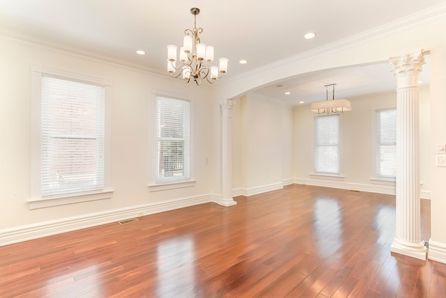 416 E 8th St, Newport, KY 41071 - empty room featuring hardwood / wood-style floors, arched walkways, a chandelier, ornate columns, and ornamental molding