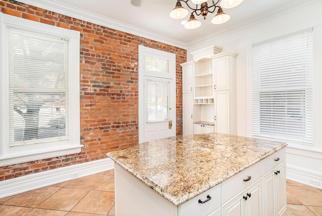 416 E 8th St, Newport, KY 41071 - kitchen with brick wall, a chandelier, light stone counters, healthy amount of natural light, and ornamental molding