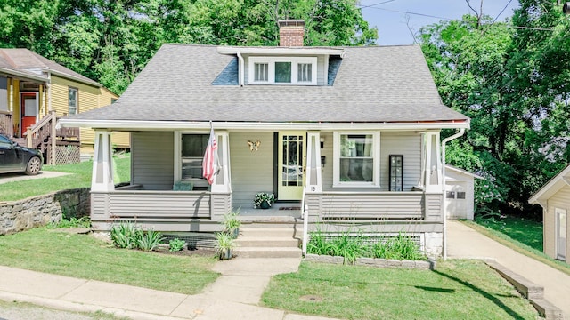 15 21st St, Newport, KY 41071 - bungalow-style house featuring a porch, roof with shingles, a chimney, and a front lawn