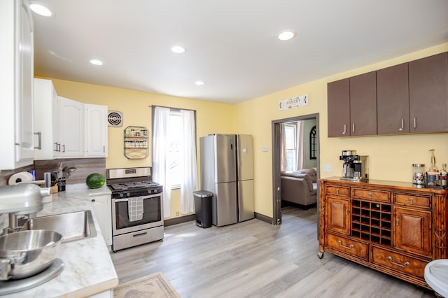 15 21st St, Newport, KY 41071 - kitchen with stainless steel appliances, light countertops, white cabinetry, light wood-style flooring, and recessed lighting