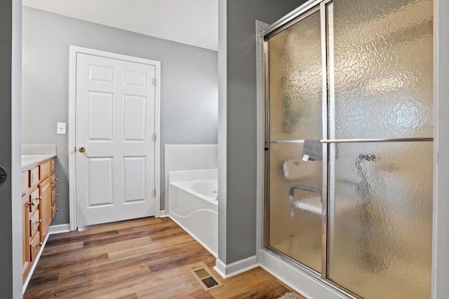 10302 Limerick Cir, Covington, KY 41015 - full bath with wood finished floors, a shower stall, vanity, and a bath