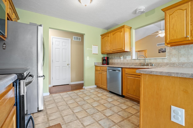 10302 Limerick Cir, Covington, KY 41015 - kitchen featuring appliances with stainless steel finishes, decorative backsplash, a ceiling fan, lofted ceiling, and light countertops