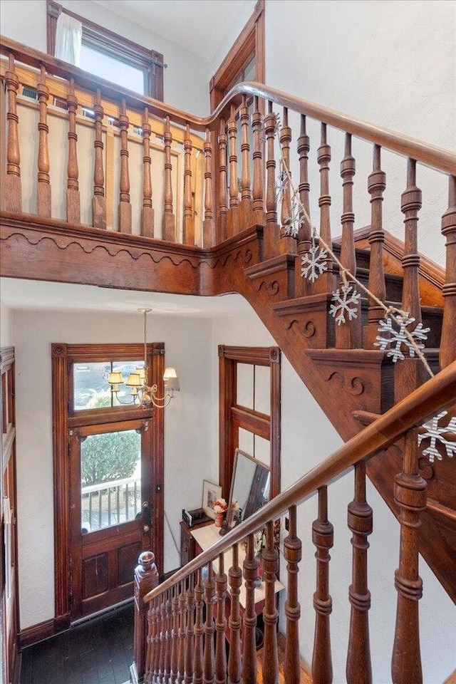 411 E 10th St, Newport, KY 41071 - stairs with wood finished floors and a chandelier