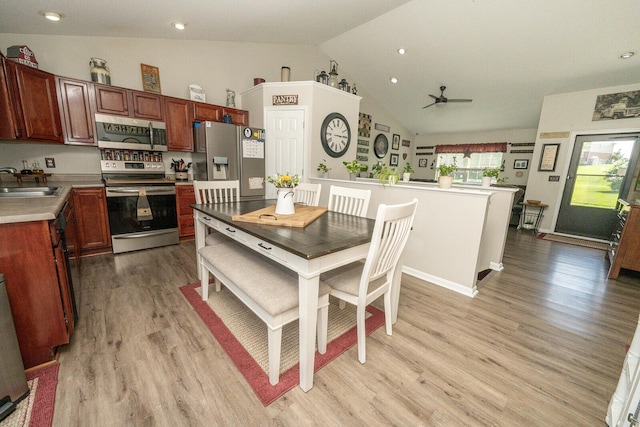 1155 Breckenridge Ln, Hebron, KY 41048 - kitchen featuring appliances with stainless steel finishes, ceiling fan, light wood-style flooring, light countertops, and high vaulted ceiling