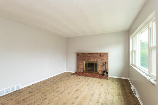 94 Mayo Cir, Newport, KY 41071 - unfurnished living room with wood finished floors and a brick fireplace