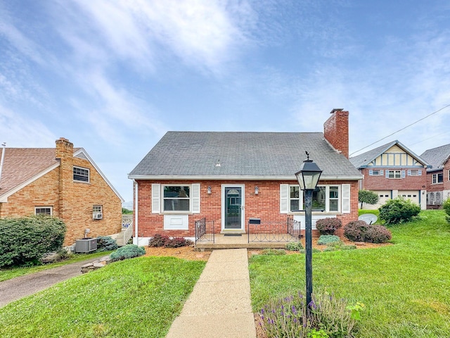 94 Mayo Cir, Newport, KY 41071 - view of front facade featuring a front lawn, brick siding, roof with shingles, and a chimney