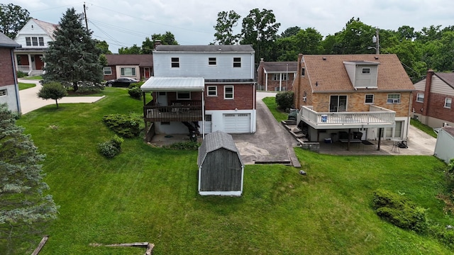 94 Mayo Cir, Newport, KY 41071 - rear view of house featuring an attached garage, a deck, and a yard