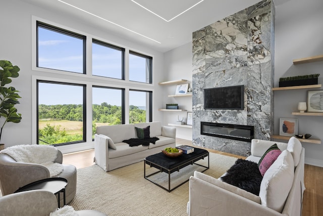 5090 Bella Vista Dr, Cold Spring, KY 41076 - living room featuring wood finished floors, healthy amount of natural light, a fireplace, and a towering ceiling