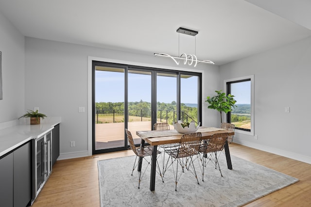 5090 Bella Vista Dr, Cold Spring, KY 41076 - dining room featuring a chandelier, light wood-style floors, and wine cooler