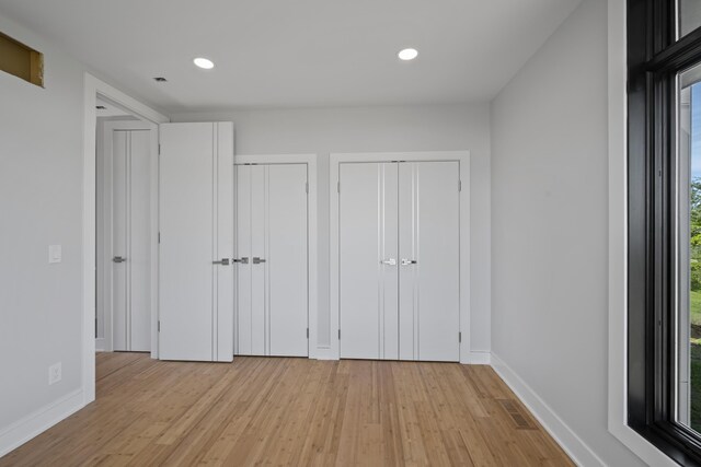 5090 Bella Vista Dr, Cold Spring, KY 41076 - unfurnished bedroom with multiple closets, light wood-style flooring, and recessed lighting