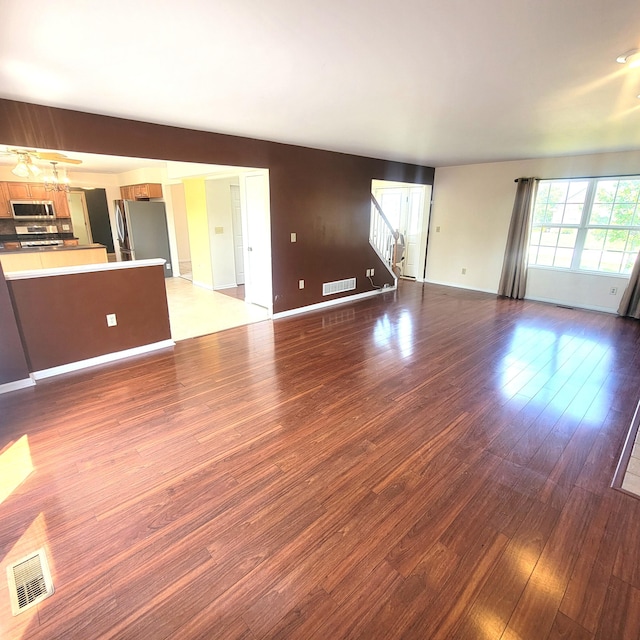 4467 Hackberry Ct, Burlington, KY 41005 - unfurnished living room featuring wood finished floors and stairway
