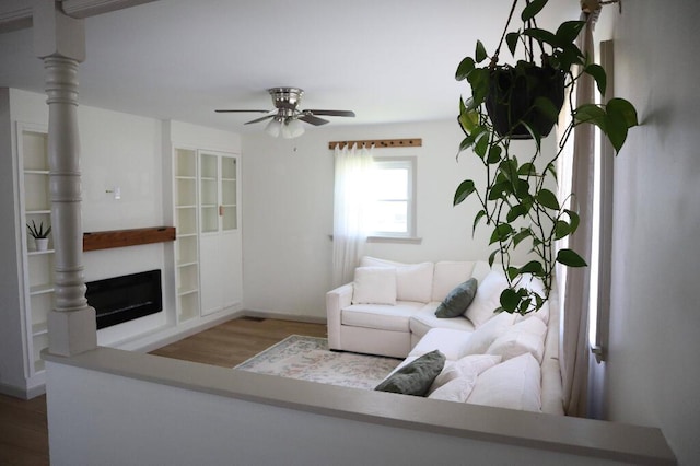 713 Ferncliffe Ave, Crescent Springs, KY 41017 - living room with wood finished floors, a ceiling fan, and a fireplace