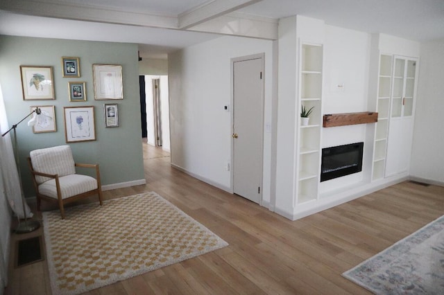 713 Ferncliffe Ave, Crescent Springs, KY 41017 - sitting room featuring wood finished floors and a glass covered fireplace