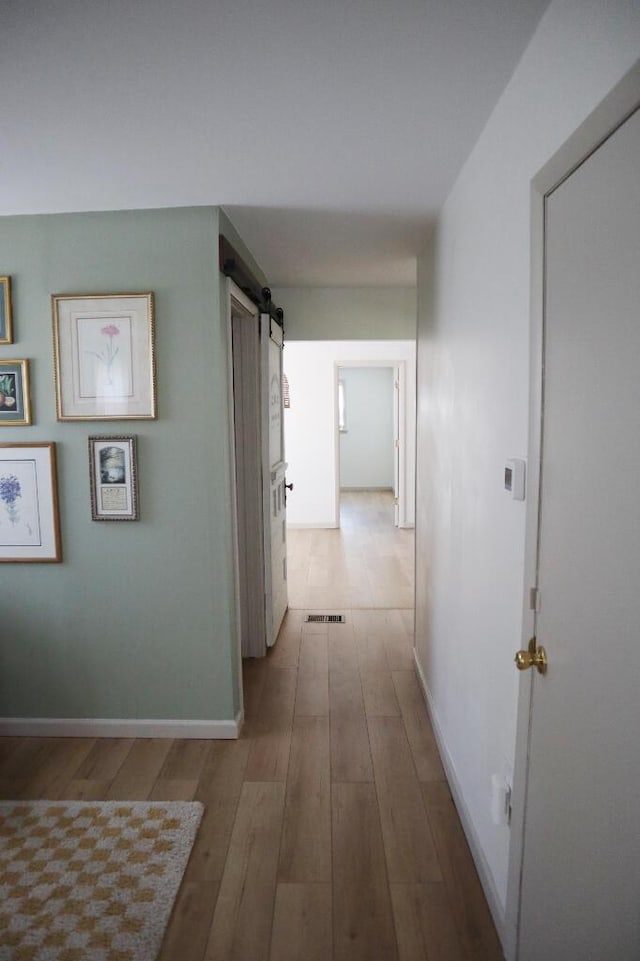 713 Ferncliffe Ave, Crescent Springs, KY 41017 - corridor with wood finished floors and a barn door