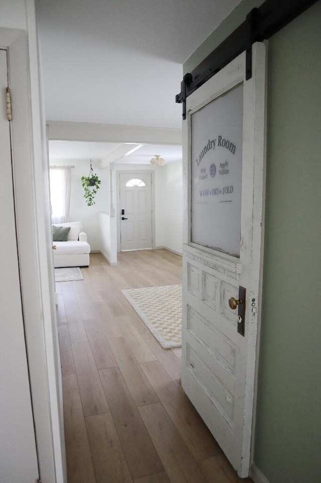 713 Ferncliffe Ave, Crescent Springs, KY 41017 - hallway featuring a barn door and wood finished floors