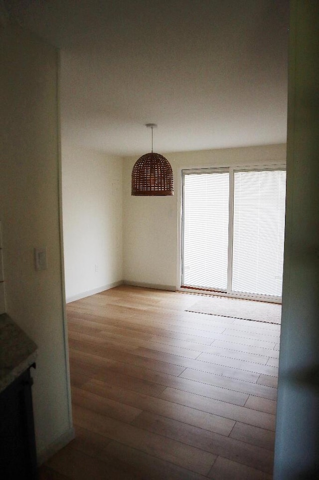 713 Ferncliffe Ave, Crescent Springs, KY 41017 - unfurnished dining area featuring wood finished floors and baseboards