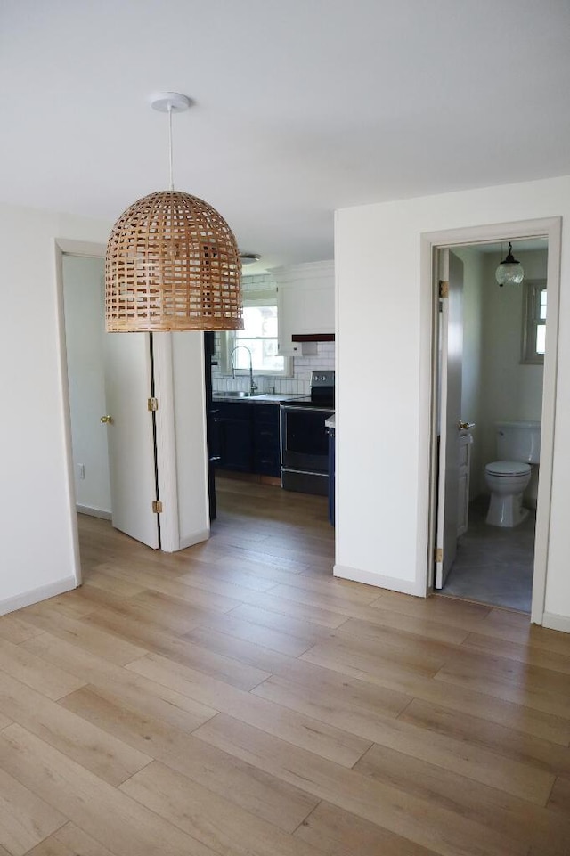 713 Ferncliffe Ave, Crescent Springs, KY 41017 - unfurnished dining area featuring light wood-type flooring and a sink