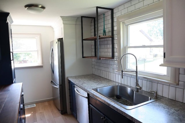 713 Ferncliffe Ave, Crescent Springs, KY 41017 - kitchen featuring stainless steel appliances, healthy amount of natural light, tasteful backsplash, and open shelves