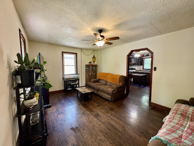 12155 Riggs Rd, Independence, KY 41051 - living room with a ceiling fan, a textured ceiling, dark wood-style flooring, and arched walkways