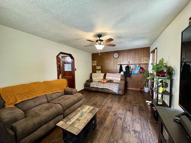 12155 Riggs Rd, Independence, KY 41051 - bedroom with dark wood-type flooring, wooden walls, arched walkways, a textured ceiling, and a ceiling fan
