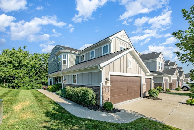 2175 Piazza Rdg, Covington, KY 41017 - view of front facade featuring board and batten siding, concrete driveway, a front lawn, roof with shingles, and brick siding