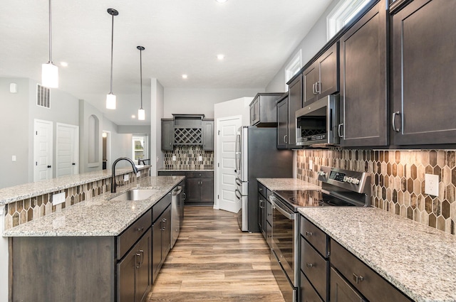 2175 Piazza Rdg, Covington, KY 41017 - kitchen featuring appliances with stainless steel finishes, dark brown cabinetry, an island with sink, and recessed lighting