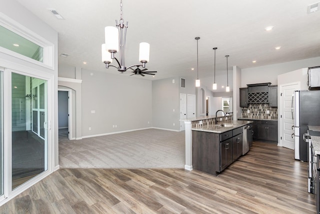 2175 Piazza Rdg, Covington, KY 41017 - kitchen featuring wood finished floors, appliances with stainless steel finishes, a chandelier, decorative backsplash, and recessed lighting