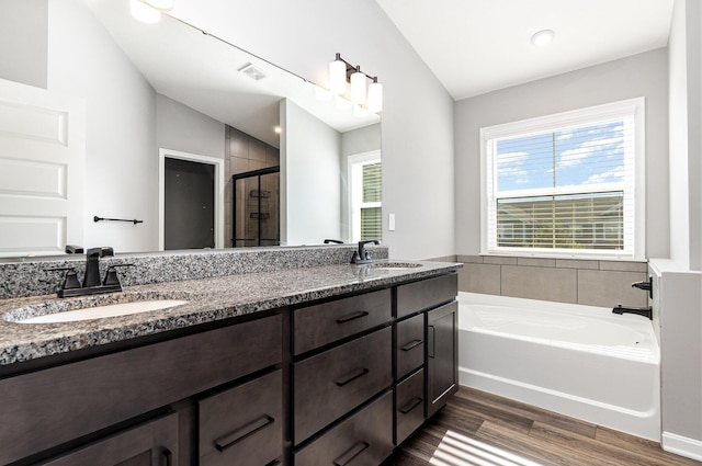 2175 Piazza Rdg, Covington, KY 41017 - bathroom featuring a bath, double vanity, wood finished floors, a shower stall, and lofted ceiling