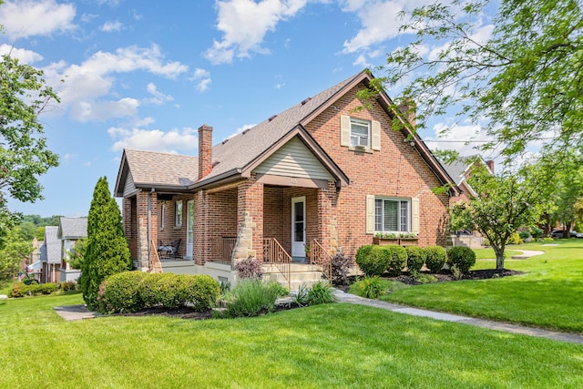 65 W Crittenden Ave, Fort Wright, KY 41011 - view of front facade with a chimney, brick siding, and a front lawn