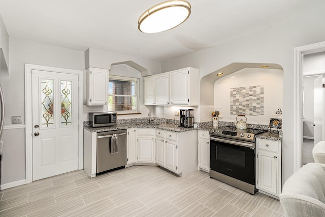 65 W Crittenden Ave, Fort Wright, KY 41011 - kitchen featuring appliances with stainless steel finishes, dark stone countertops, and white cabinets