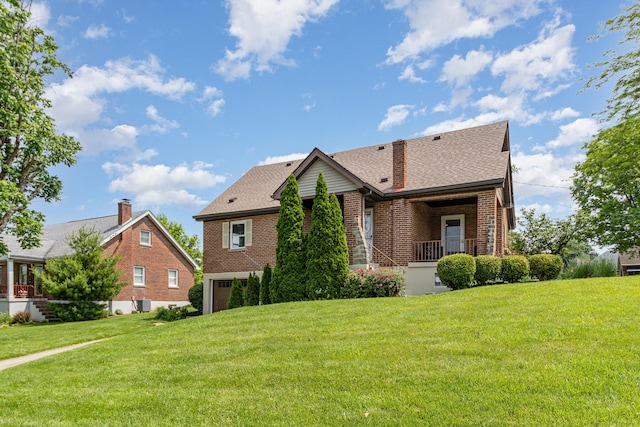 65 W Crittenden Ave, Fort Wright, KY 41011 - view of front of home with brick siding, a garage, a front yard, and roof with shingles
