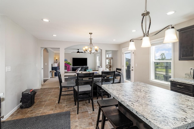 1353 Dominion Trl, Hebron, KY 41048 - dining area with arched walkways, a chandelier, recessed lighting, and stone finish floors