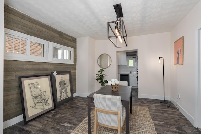 21141/2 Glenway Ave, Covington, KY 41014 - dining room featuring wood walls, dark wood-style floors, a textured ceiling, healthy amount of natural light, and a chandelier
