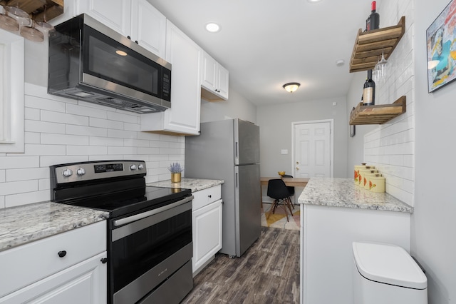 21141/2 Glenway Ave, Covington, KY 41014 - kitchen featuring appliances with stainless steel finishes, white cabinets, backsplash, dark wood-style floors, and light stone counters