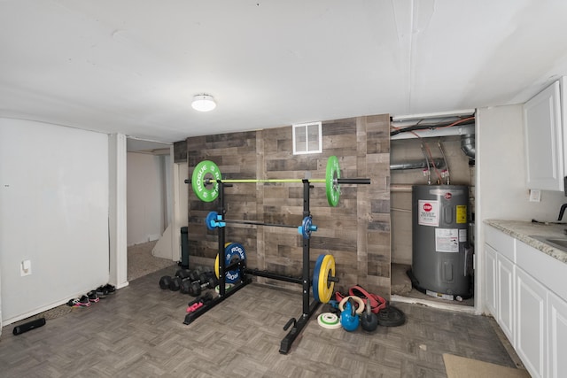 21141/2 Glenway Ave, Covington, KY 41014 - exercise room featuring water heater and wooden walls