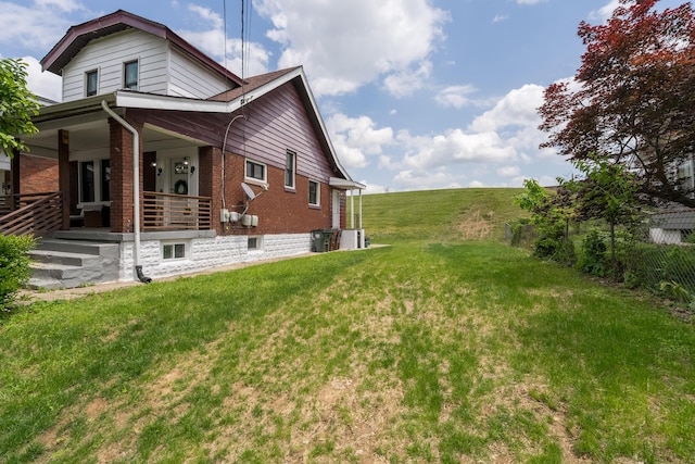 21141/2 Glenway Ave, Covington, KY 41014 - view of property exterior with brick siding, a porch, and a yard
