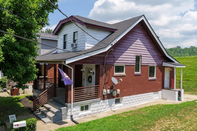 21141/2 Glenway Ave, Covington, KY 41014 - bungalow featuring covered porch, brick siding, a front lawn, and roof with shingles
