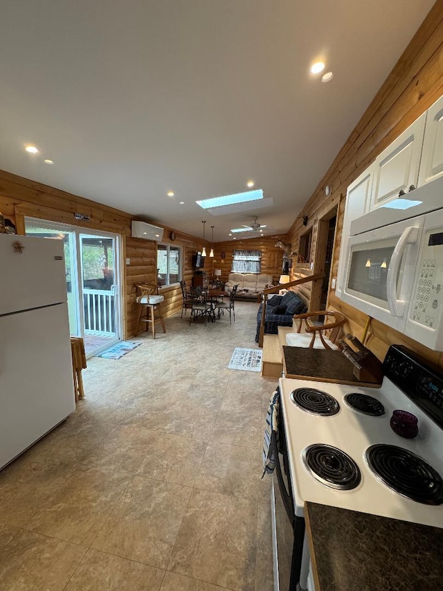 445 Davis Lake Rd # 1, Owenton, KY 40359 - kitchen with white appliances, a skylight, wooden walls, white cabinets, and recessed lighting
