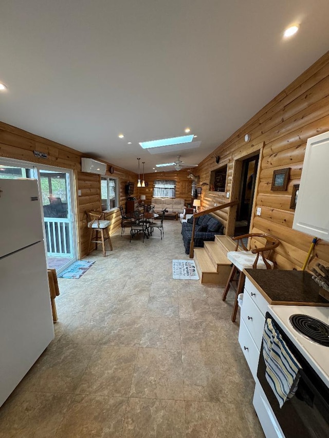 445 Davis Lake Rd # 1, Owenton, KY 40359 - kitchen featuring log walls, white appliances, a skylight, recessed lighting, and white cabinets