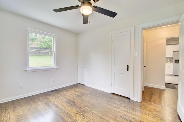 797 Highland Ave, Fort Wright, KY 41011 - unfurnished bedroom with stainless steel refrigerator with ice dispenser, wood finished floors, and a ceiling fan