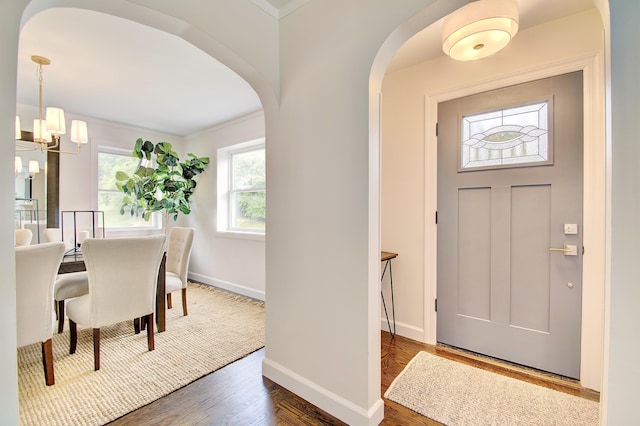 797 Highland Ave, Fort Wright, KY 41011 - foyer with a chandelier, arched walkways, wood finished floors, and ornamental molding