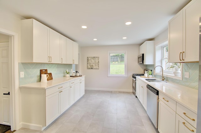 797 Highland Ave, Fort Wright, KY 41011 - kitchen featuring stainless steel appliances, backsplash, white cabinets, recessed lighting, and light tile patterned floors