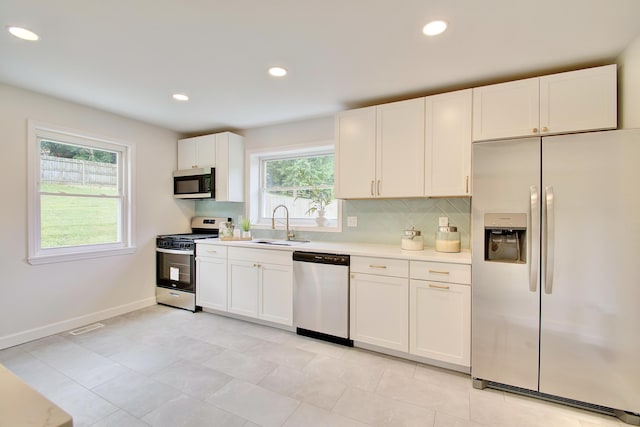 797 Highland Ave, Fort Wright, KY 41011 - kitchen featuring stainless steel appliances, light countertops, backsplash, white cabinetry, and recessed lighting
