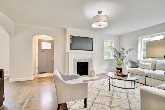 797 Highland Ave, Fort Wright, KY 41011 - living room featuring crown molding, arched walkways, wood finished floors, and a fireplace