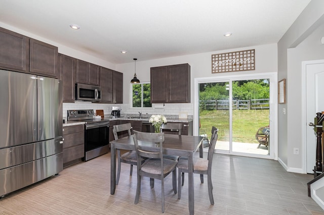928 Darlington Creek Dr, Alexandria, KY 41001 - kitchen with stainless steel appliances, decorative backsplash, dark brown cabinetry, decorative light fixtures, and recessed lighting