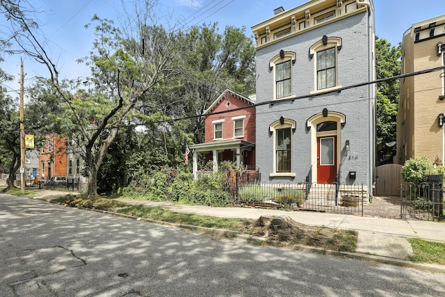 310 W Robbins St, Covington, KY 41011 - italianate home with brick siding, a fenced front yard, and a gate
