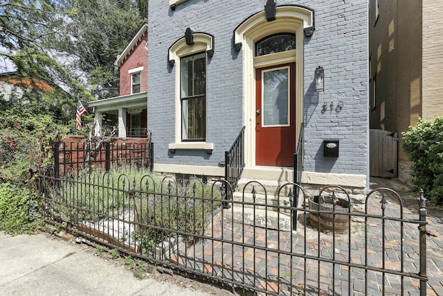 310 W Robbins St, Covington, KY 41011 - view of exterior entry featuring brick siding and a gate